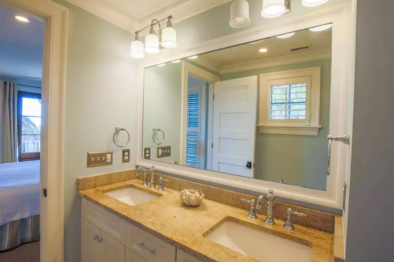 The en suite bathroom for the lower level master suite has a double sink vanity.