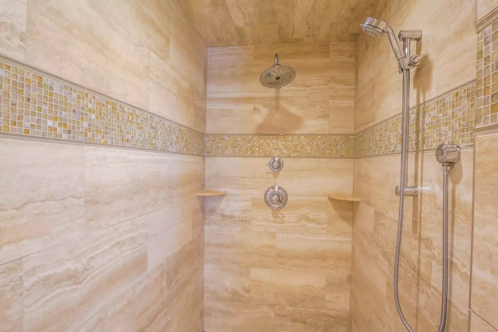 The tiled, walk-in shower in the lower level master suite has two shower heads.