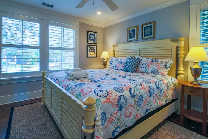 This guest suite on the home's lower level features a king bed and night stands with reading lamps.
