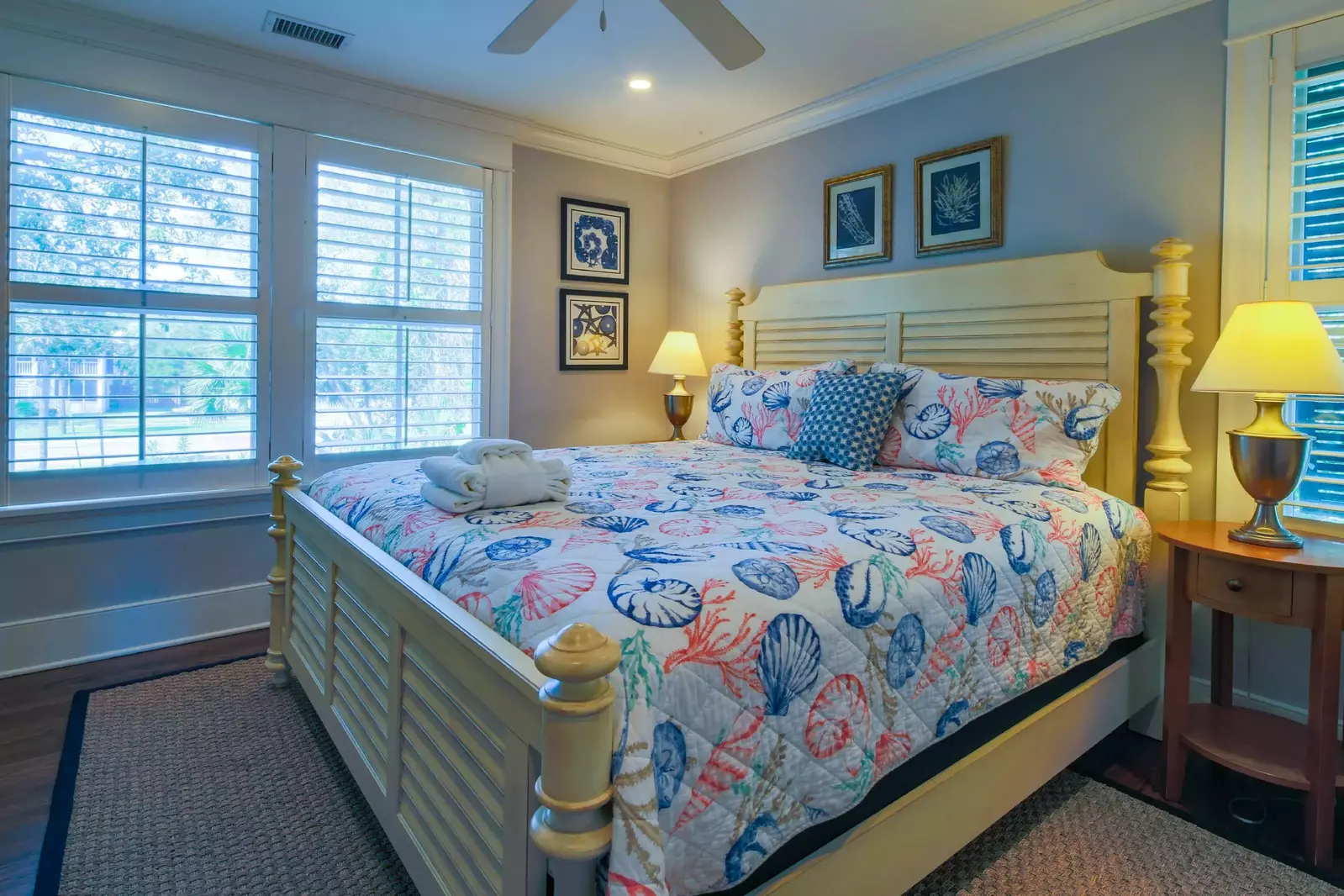 This guest suite on the home's lower level features a king bed and night stands with reading lamps.