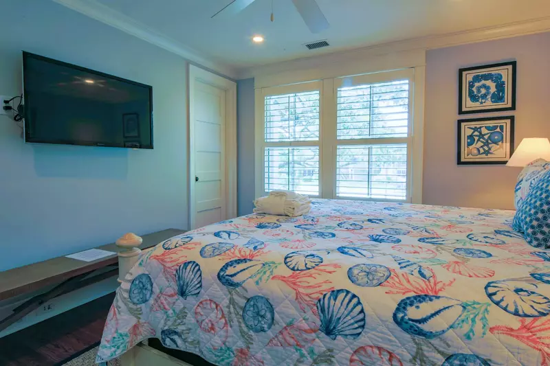 This guest suite also has a mounted smart TV and en suite bathroom.