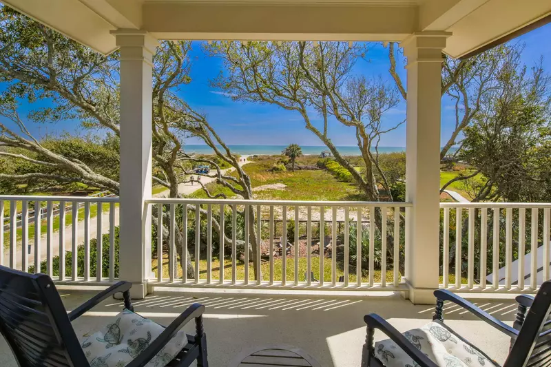 The den opens onto the partially covered deck with ocean views.
