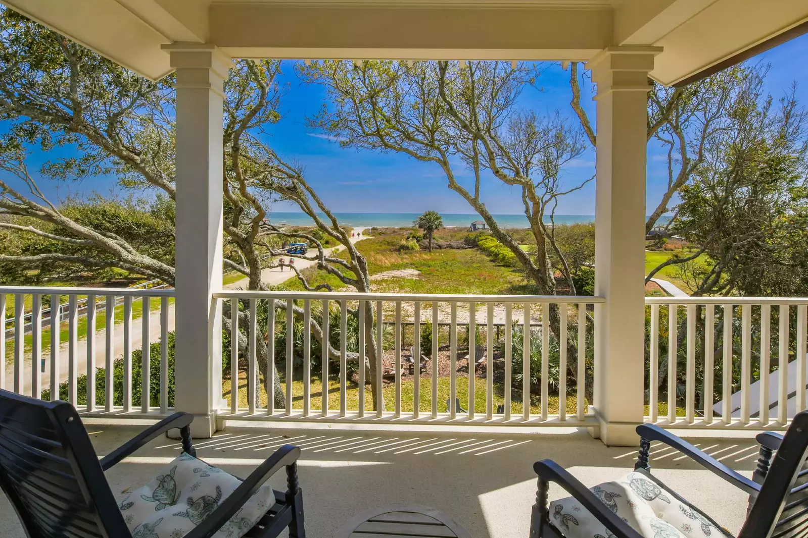 The den opens onto the partially covered deck with ocean views.
