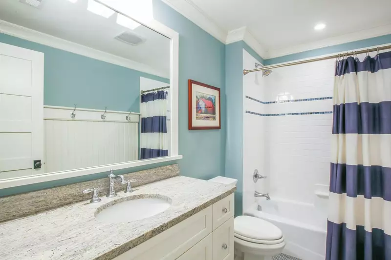 This second floor bathroom features a spacious vanity and a shower/tub combo.