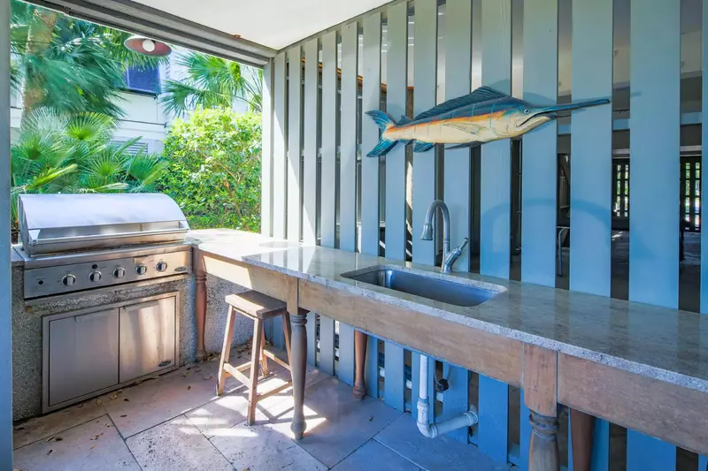 There is an outdoor grill and sink on the covered patio.