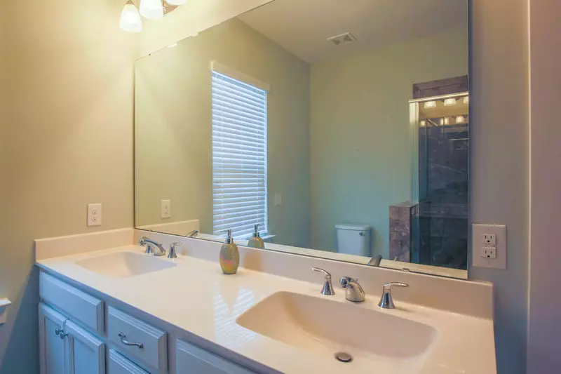 The master bathroom has a double sink vanity.