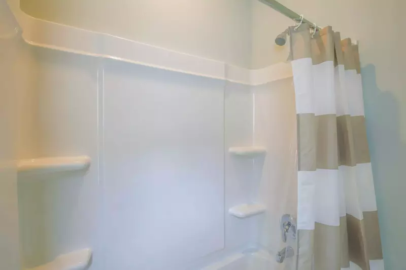 The hallway bathroom has a shower/tub combo.