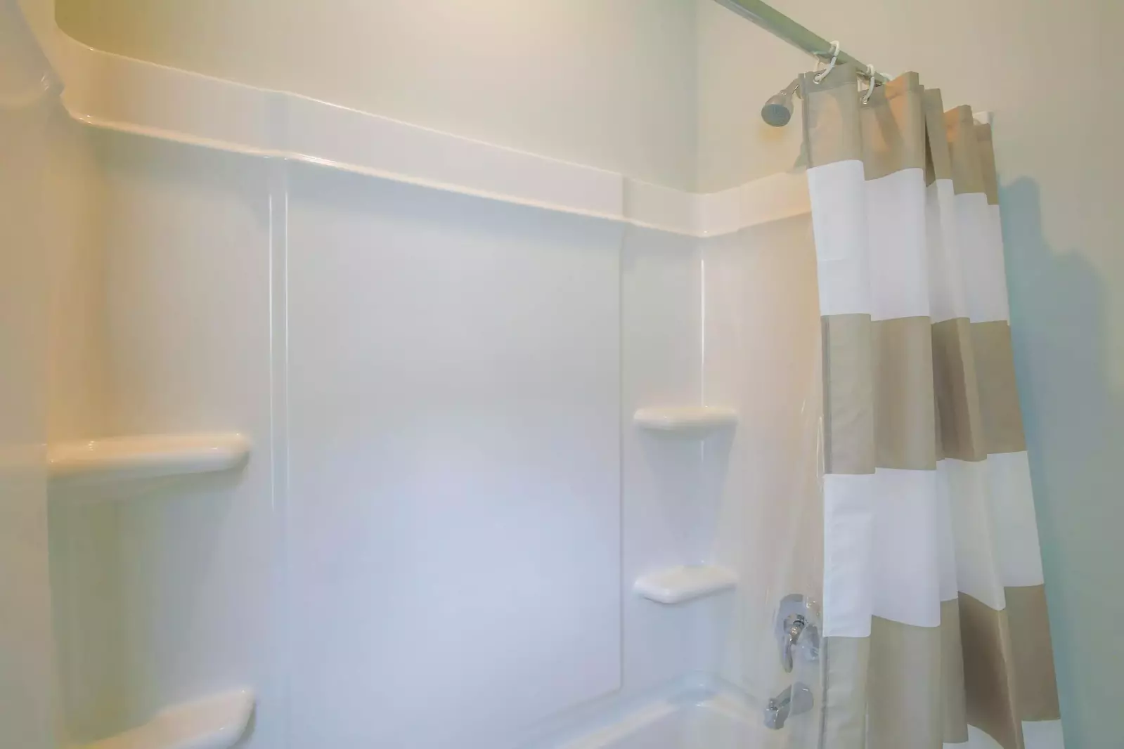 The hallway bathroom has a shower/tub combo.