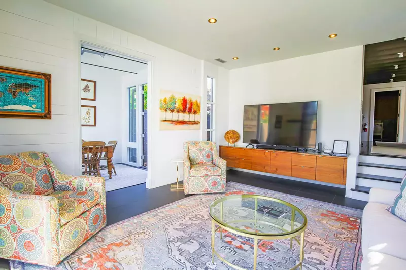 The spacious living room is situated between the sunroom and the kitchen.