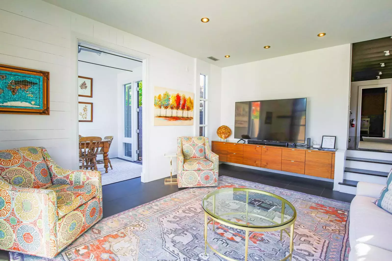 The spacious living room is situated between the sunroom and the kitchen.