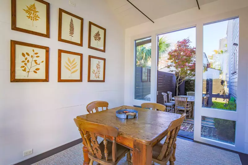 The sun room has a dining table that seats 4 and views of the home's private courtyard.