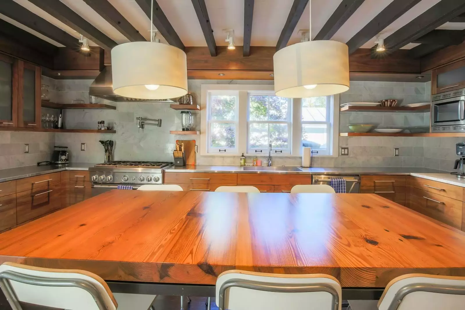 The kitchen is centered around this dining table that seats 6 people.