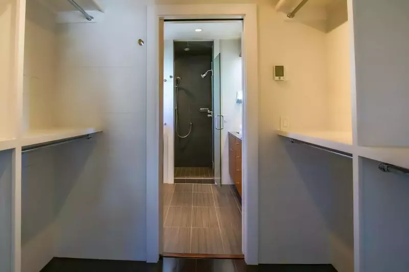 A walk-in closet separates the bedroom from the en suite bathroom.