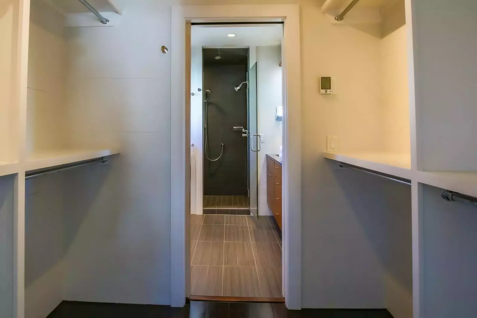 A walk-in closet separates the bedroom from the en suite bathroom.