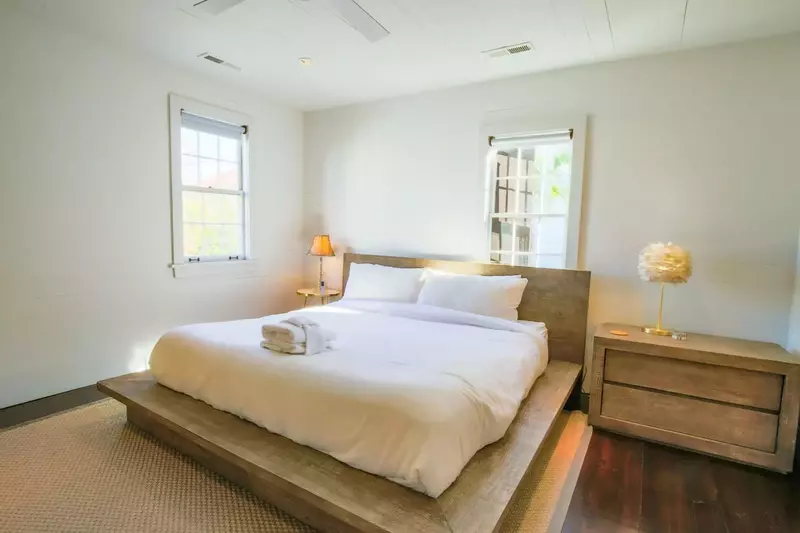 The home's second master suite features a king bed, night stands with reading lamps and terrific natural light.
