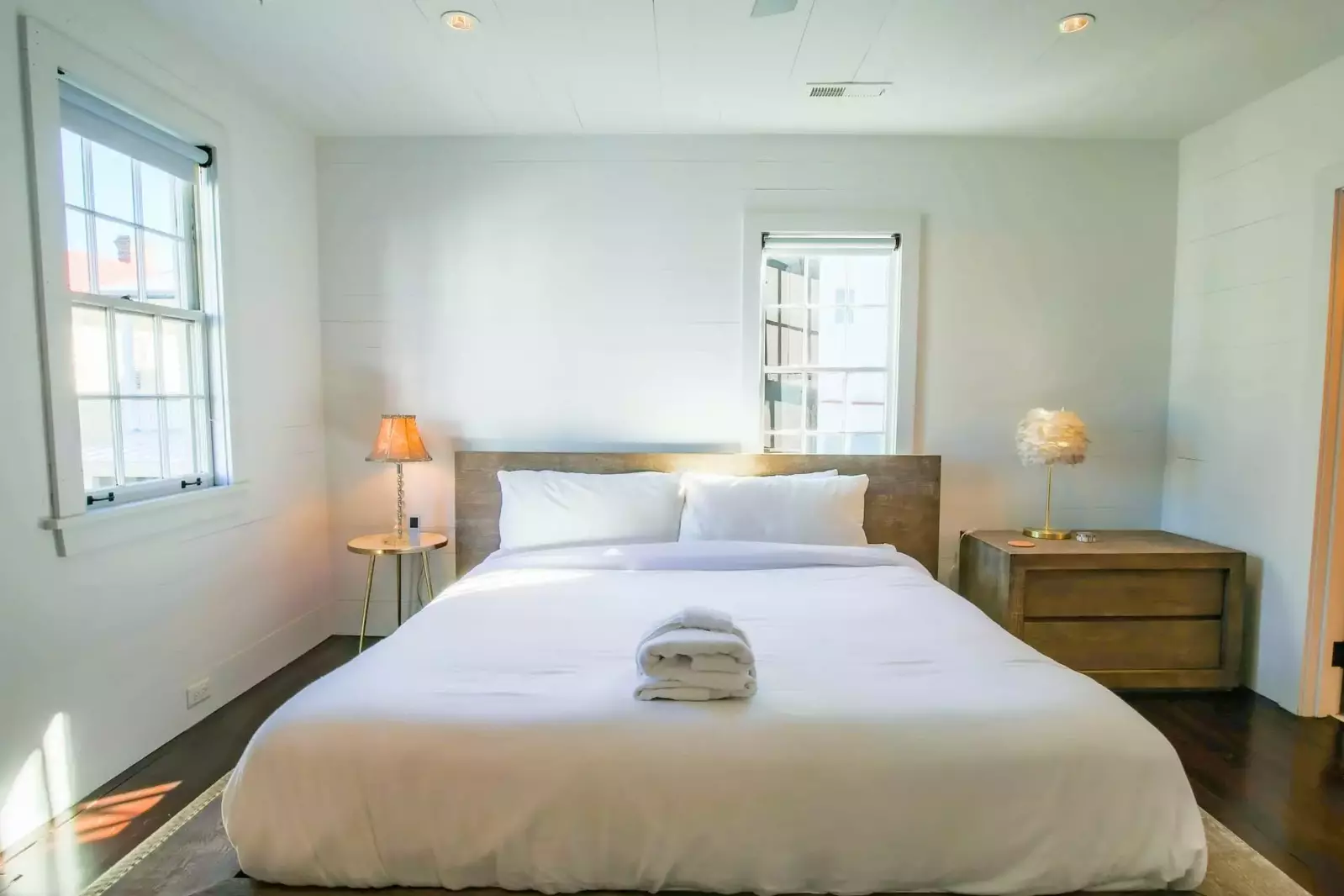 This master suite also features shiplap walls and dark hardwood floors.