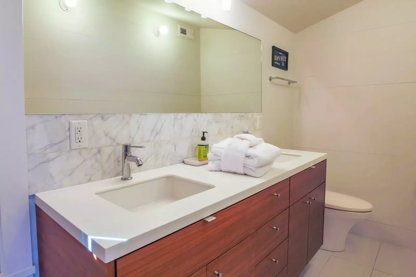 This en suite bathroom features a spacious, double sink vanity.