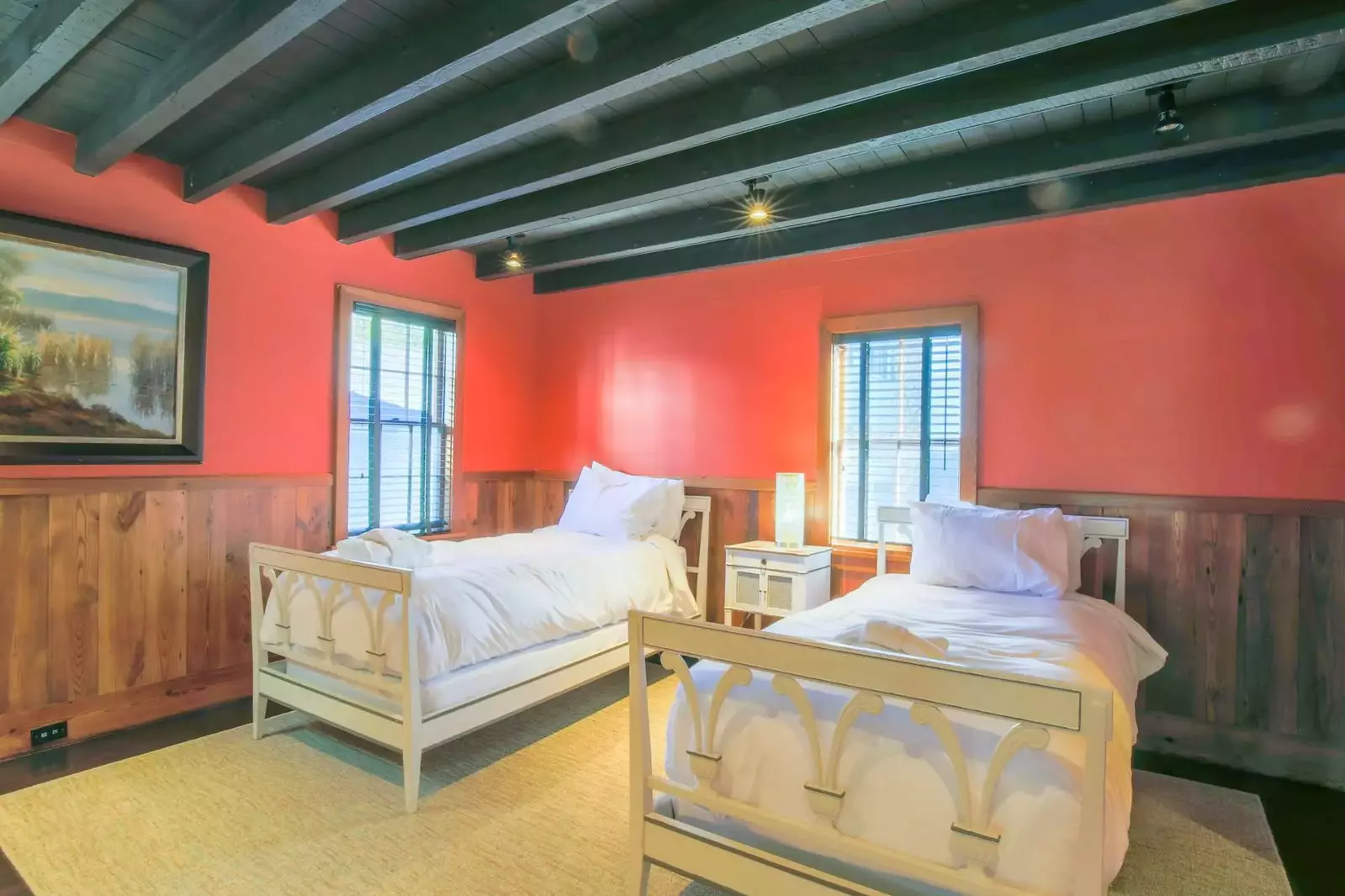 The bonus room features a beamed ceiling and wainscoting along the walls.