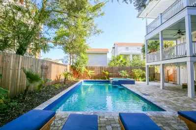 The backyard features this private pool, hot tub, paved sun deck and covered patio.