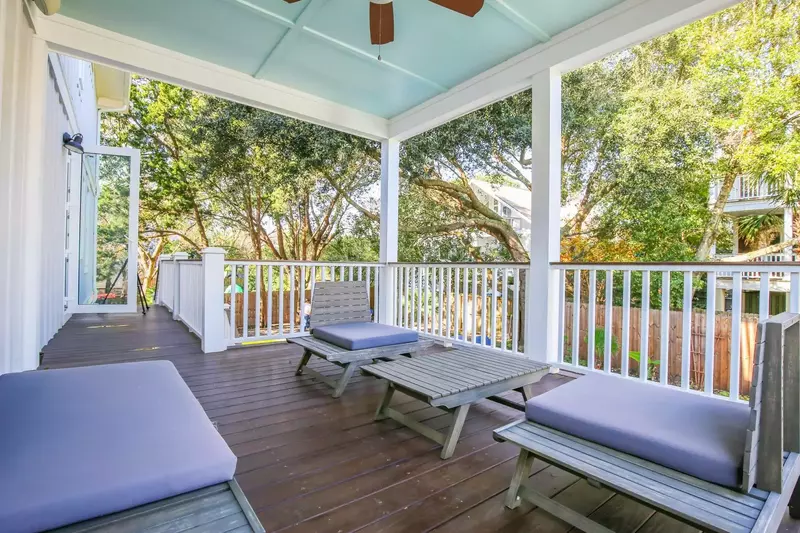 This back deck is located off of the first floor den and it overlooks the backyard pool.