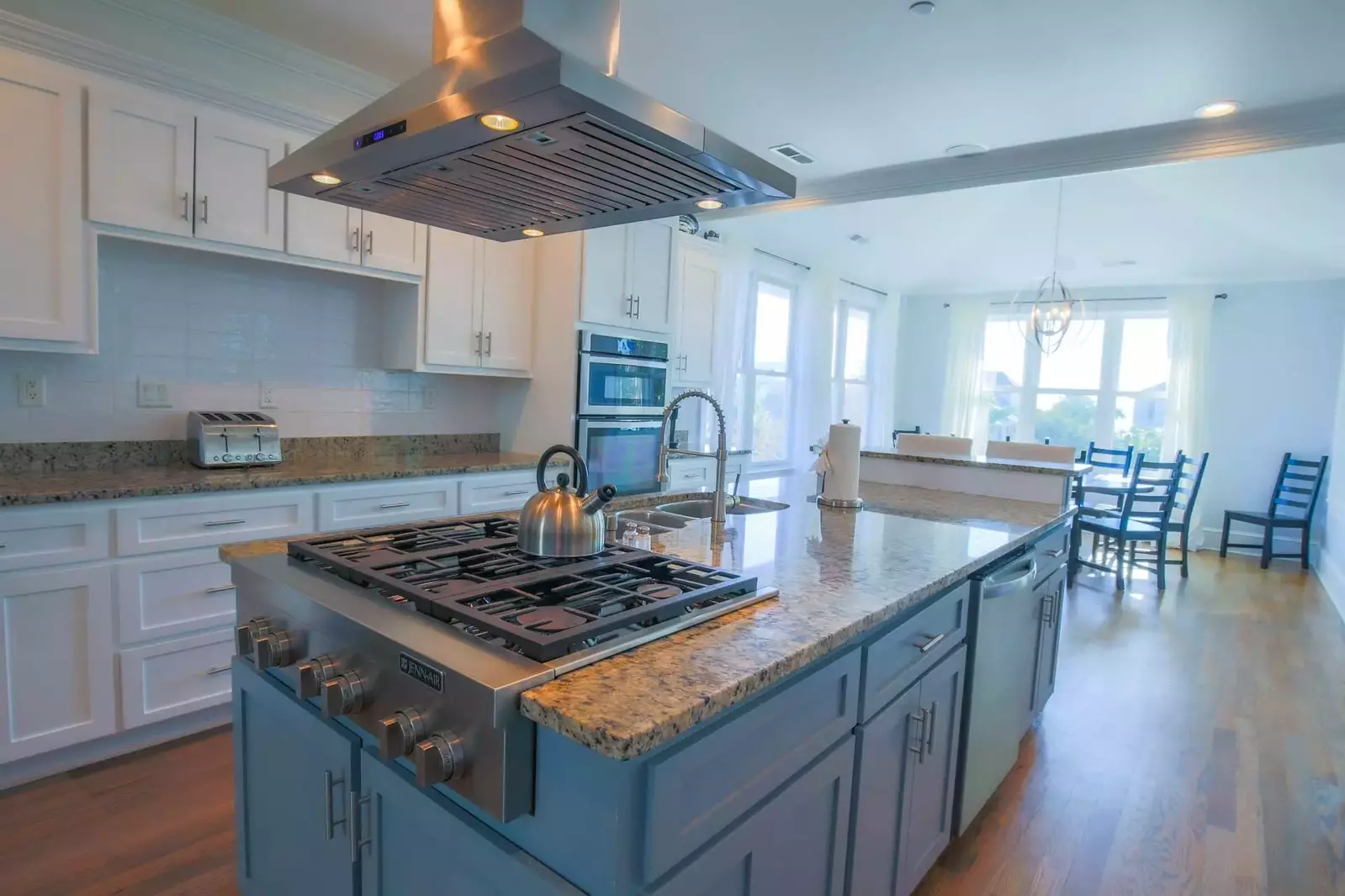 The kitchen features stainless steel appliances, granite countertops and a large island.
