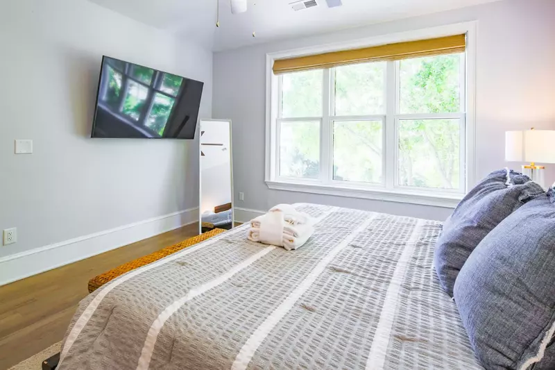 The master suite has a mounted, large screen TV.