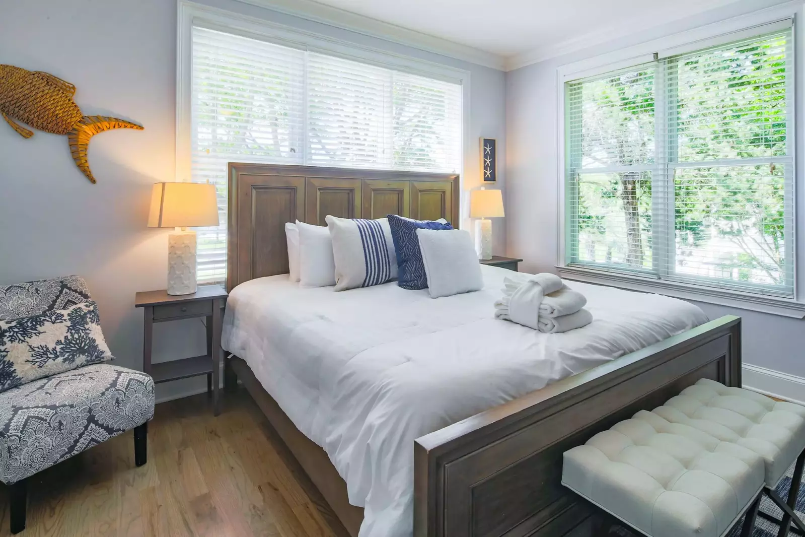 The second master suite, which is located on the first floor, has a king bed and night stands with reading lamps.