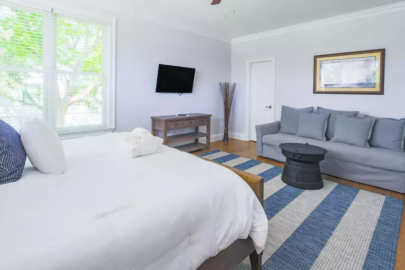 This master suite also has a mounted, streaming TV and a seating area.