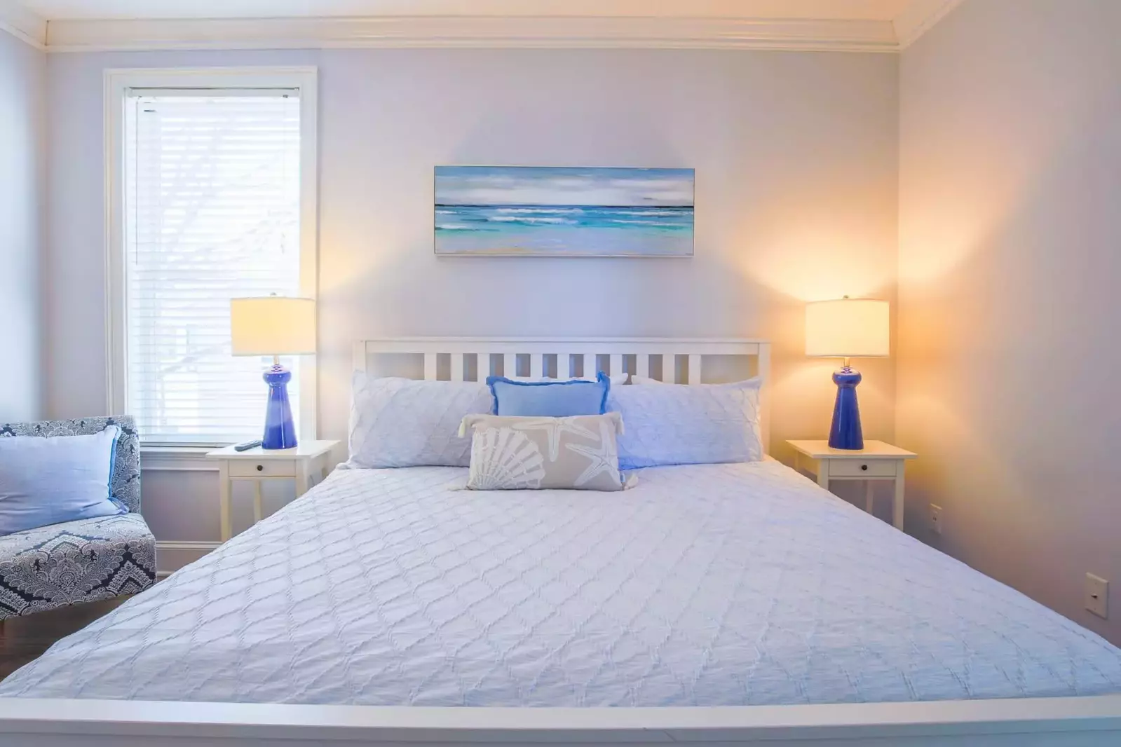This guest bedroom on the first floor has a king bed and night stands with reading lamps.
