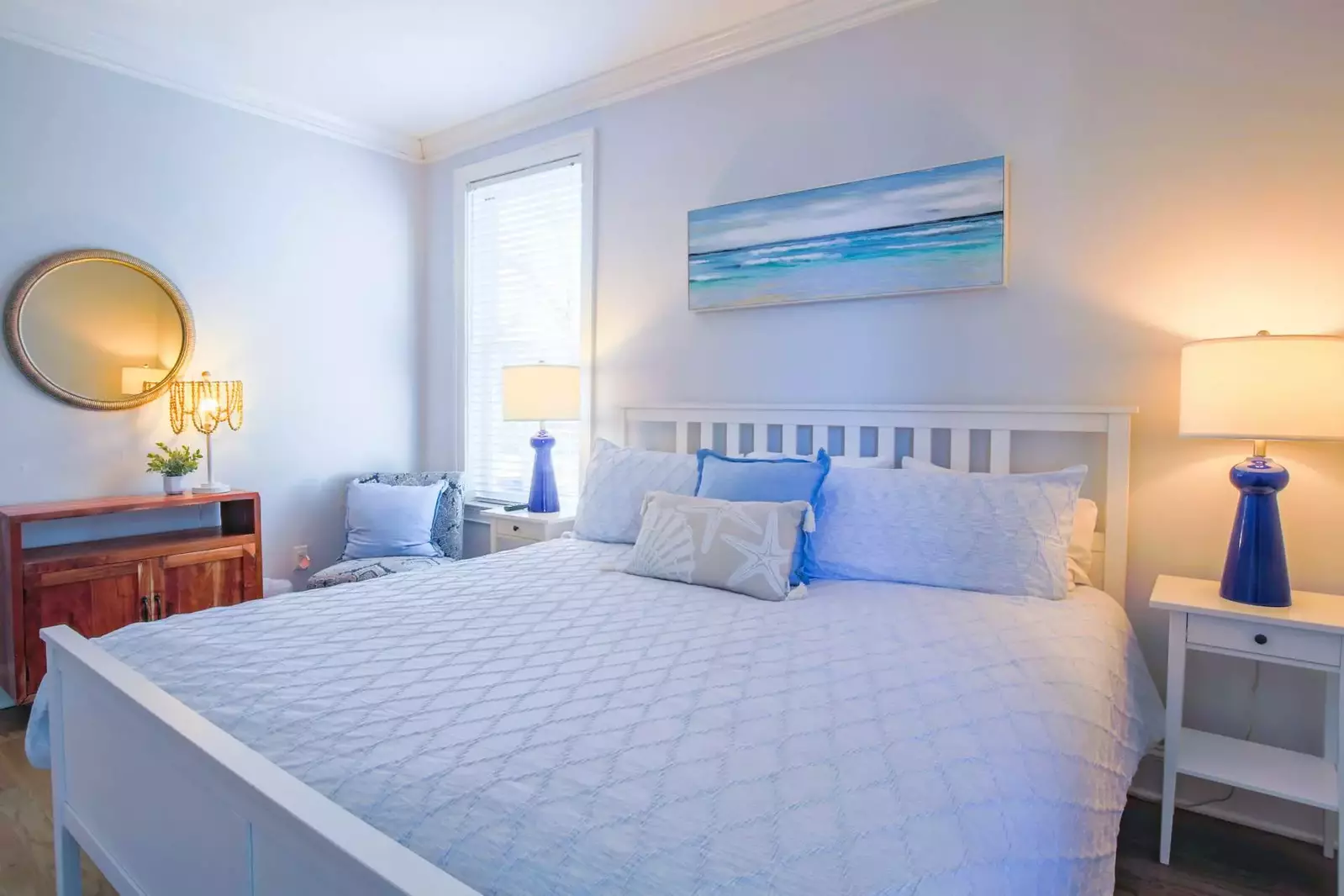 This guest bedroom also features a chair, table and mirror.