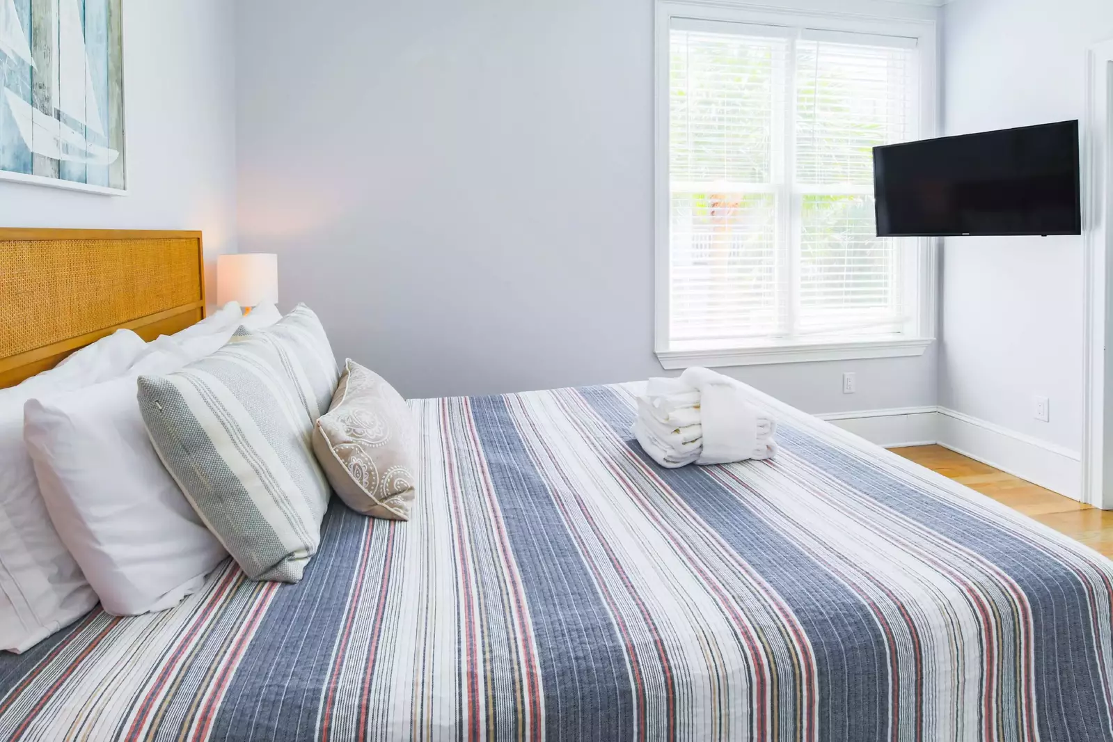This bedroom also features a mounted smart TV and access to the shared Jack & Jill bathroom.