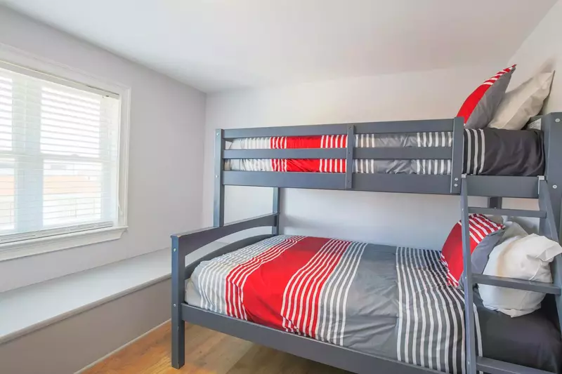 This bunk bedroom -- with a full and twin beds -- is located on one side of the game room.