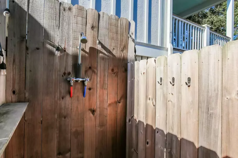 There is an outdoor shower near the pool area.