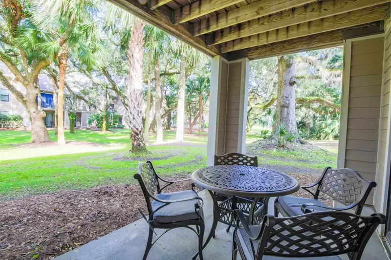 The partially covered back patio has an outdoor dining table that seats 4.