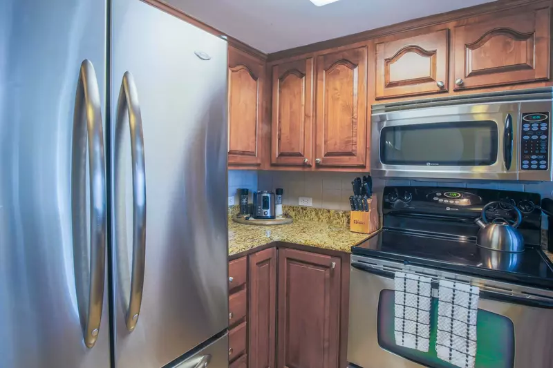 The kitchen features a drip coffee maker, toaster, microwave and range.