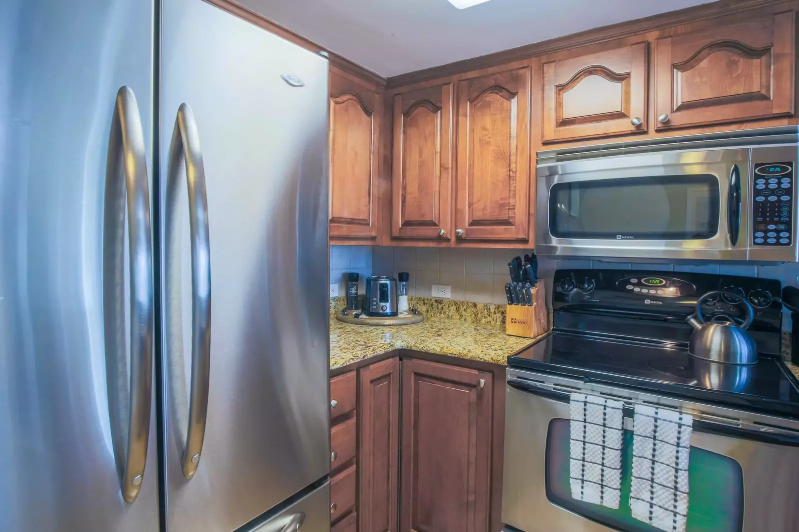 The kitchen features a drip coffee maker, toaster, microwave and range.