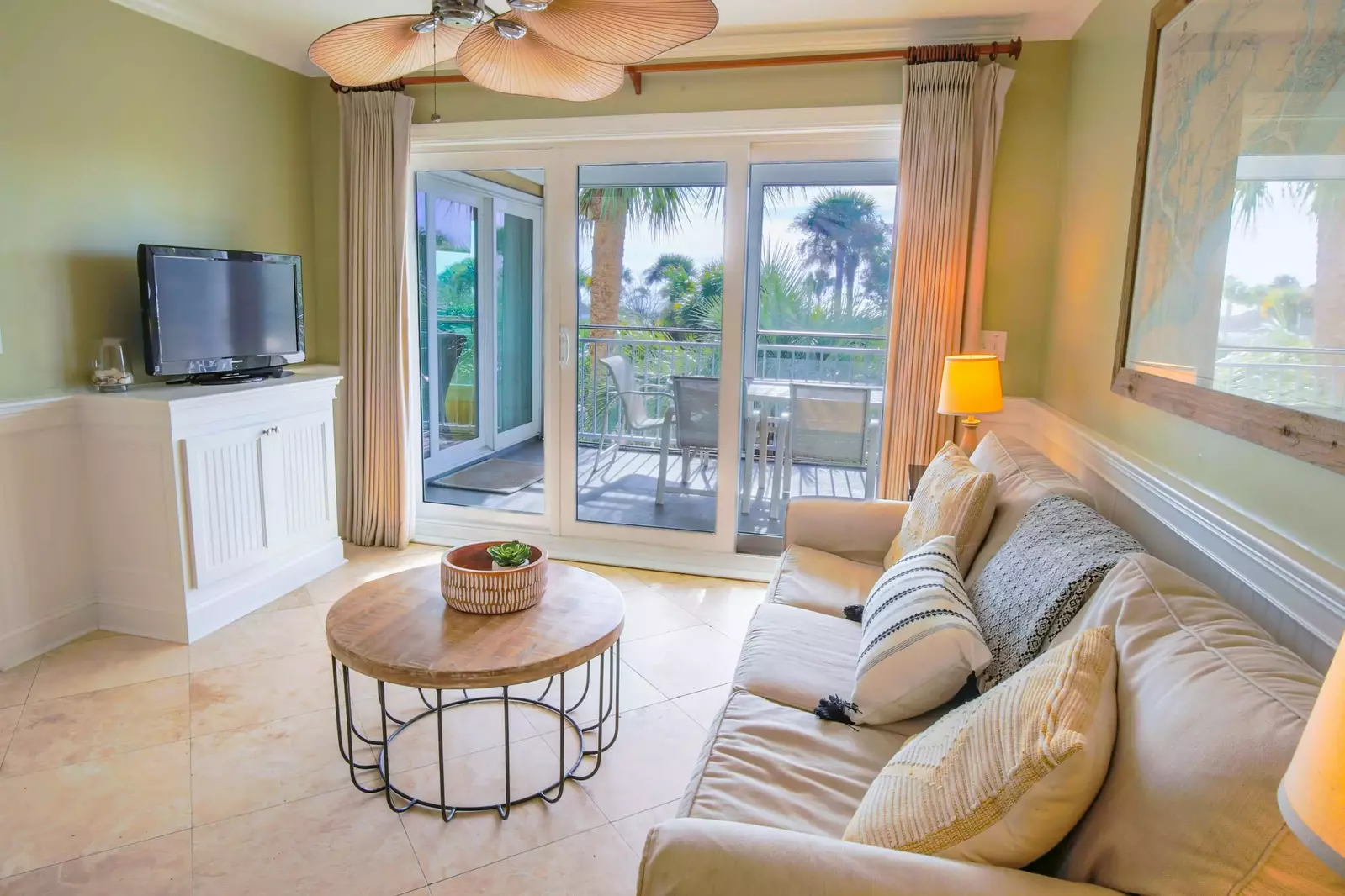 Open the sliding glass door to access the screened balcony and hear the sounds of crashing waves.