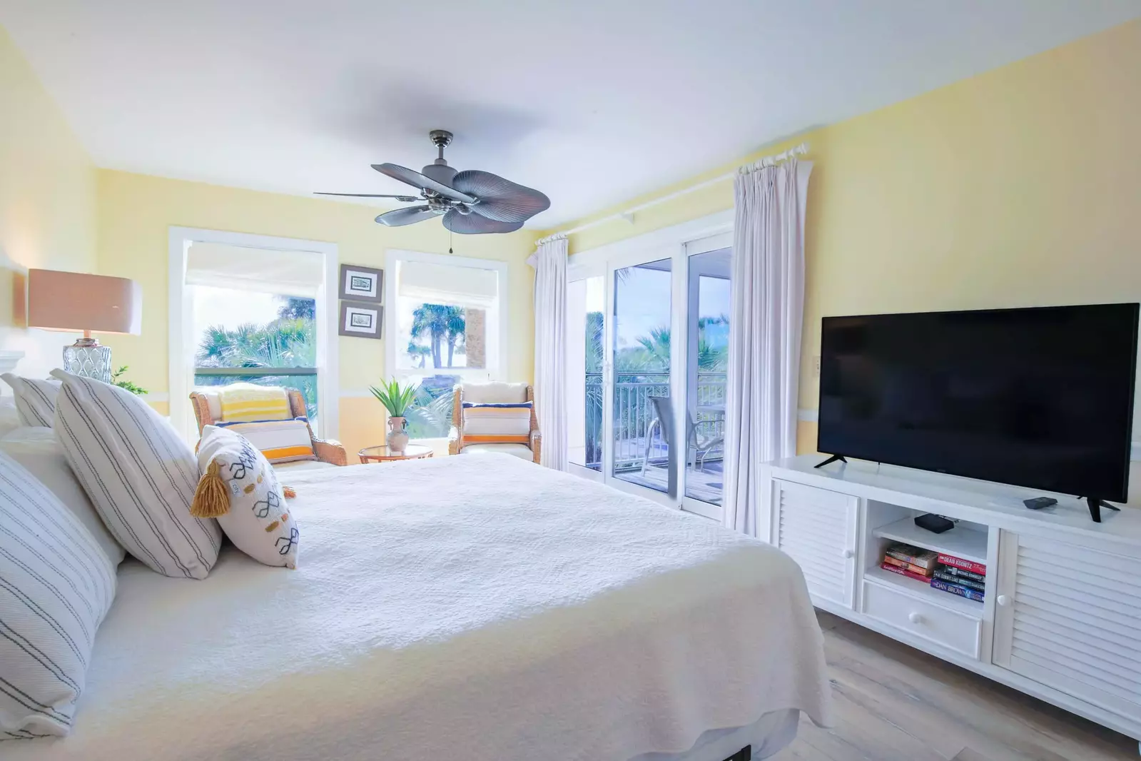 The master suite features a king bed, large screen TV and sliding door access to the screened porch.