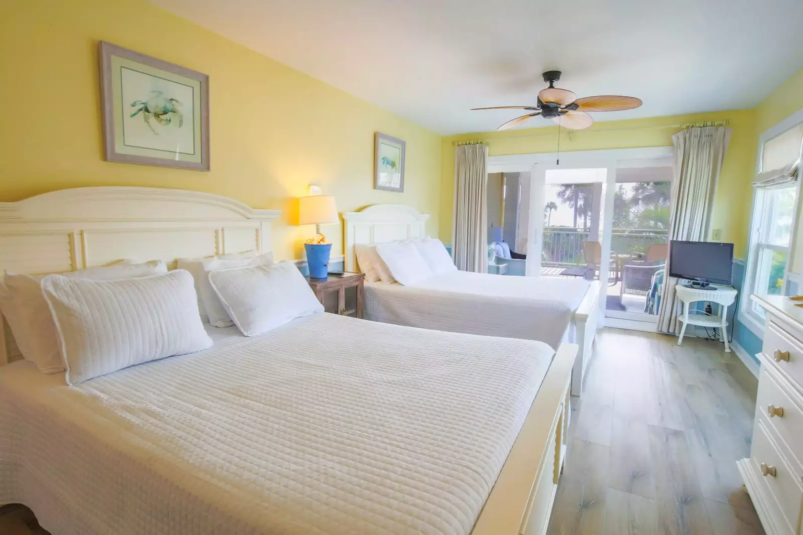 The guest suite features two queen beds and access to the screened porch.