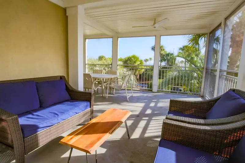 Watch the ocean waves and the evening sunset from this corner of the screened porch.