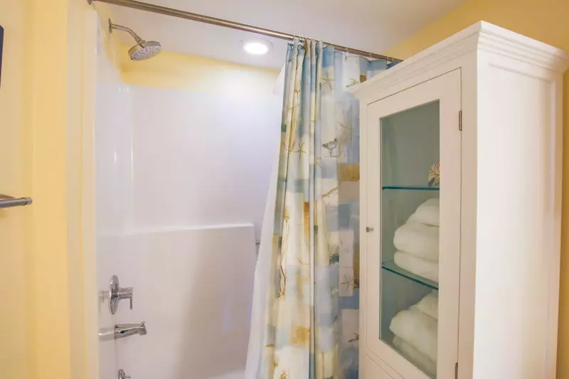 The guest suite bathroom features a shower/tub combo and multiple storage areas.