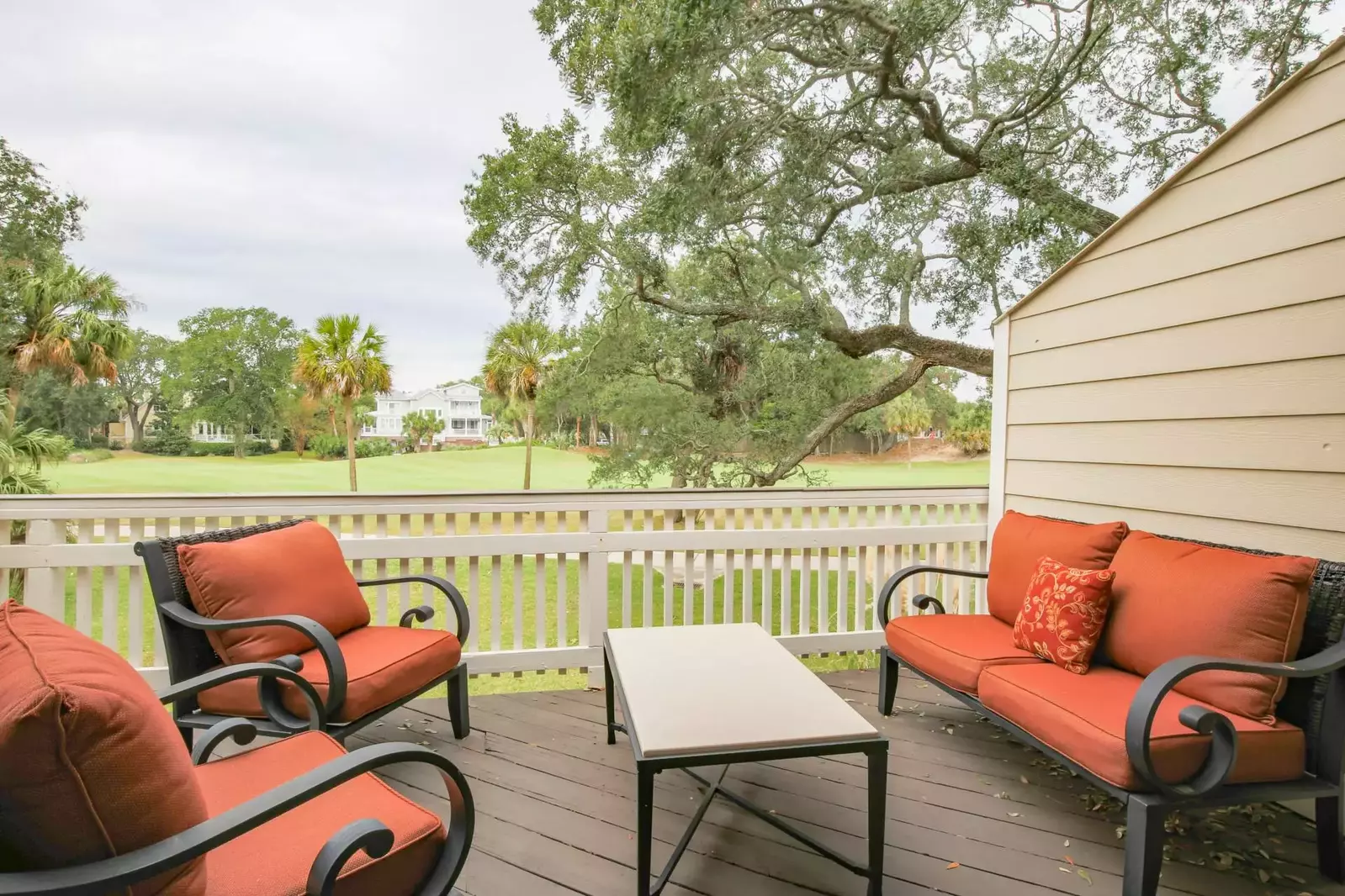 The back deck has sweeping views of the palmetto trees and live oak trees that line The Links golf course.