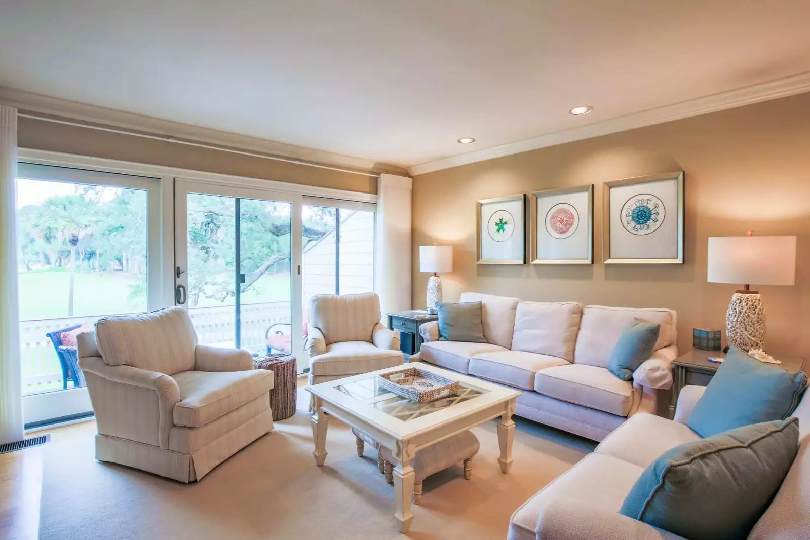 The living room receives terrific natural light through its wall of windows and glass door.