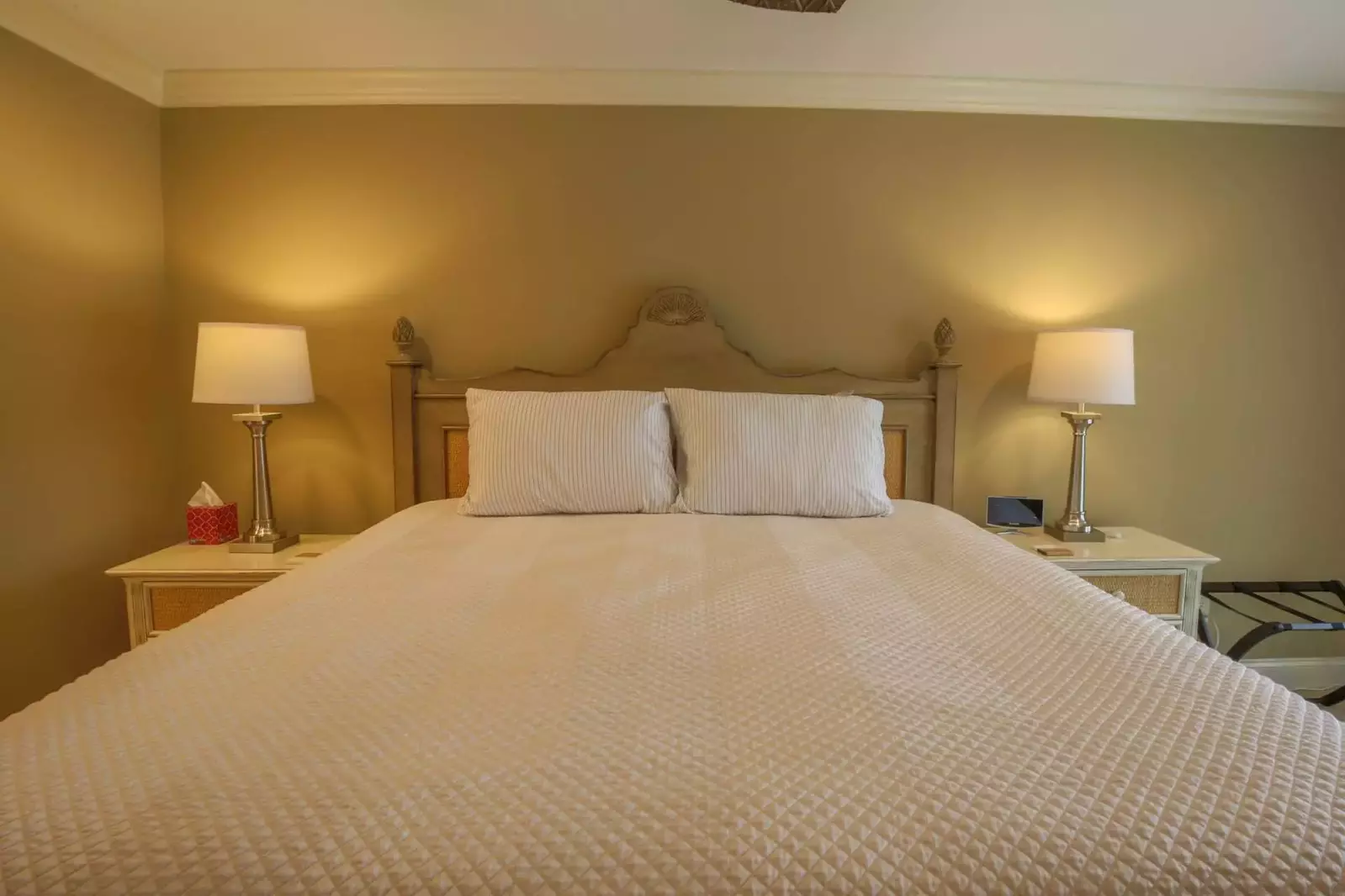 The master suite features a king bed and night stands with reading lamps.