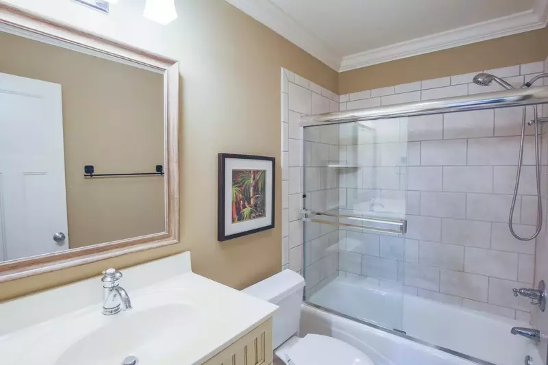 This guest suite features a vanity and a tiled shower/tub combo.