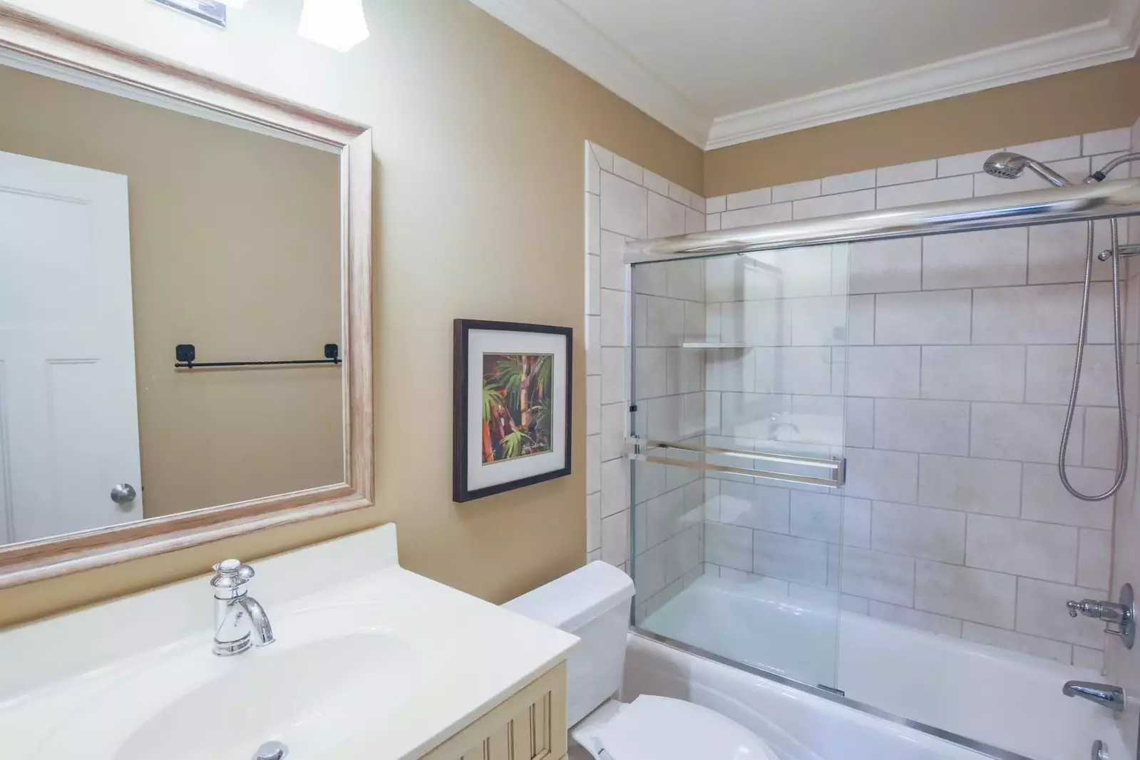 This guest suite features a vanity and a tiled shower/tub combo.