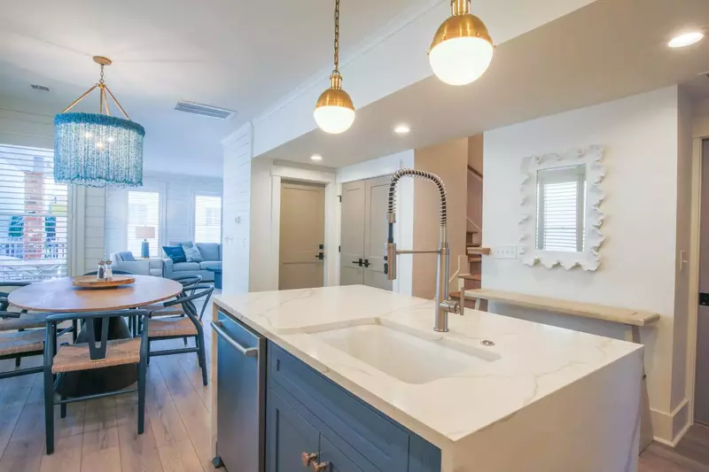The stairwell to the second and third floors is located off of the kitchen and dining area.