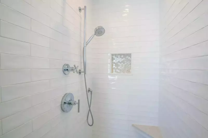 This beautifully tiled walk-in shower is located within the master suite.