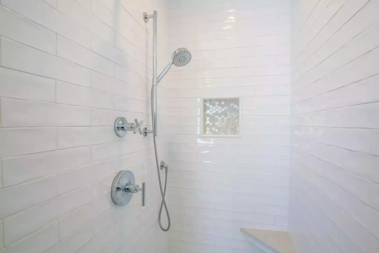 This beautifully tiled walk-in shower is located within the master suite.