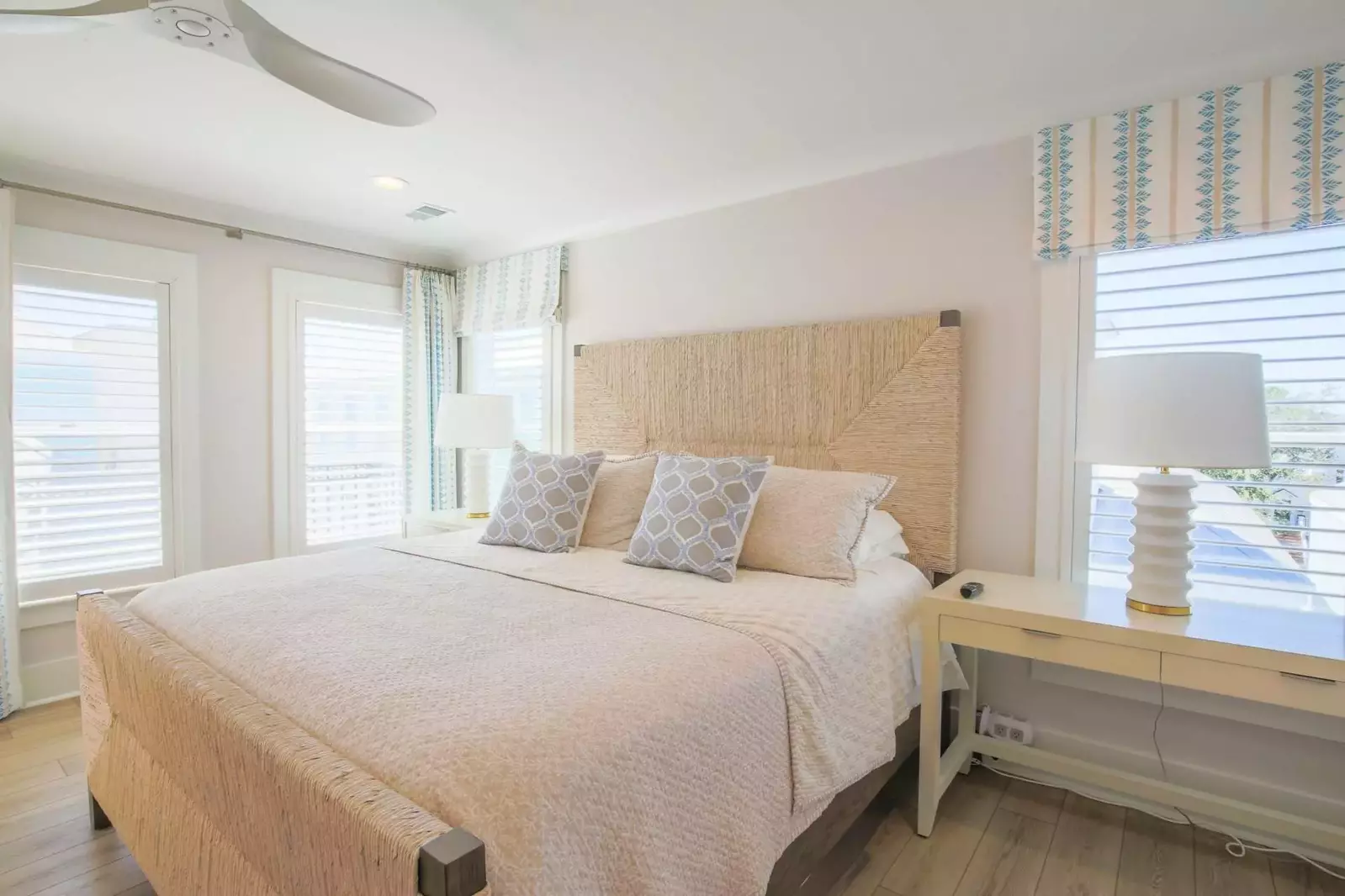 The master suite features a king bed and night stands with reading lamps.